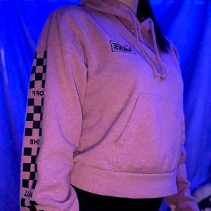 Cropped pink woman’s vans hoodie.